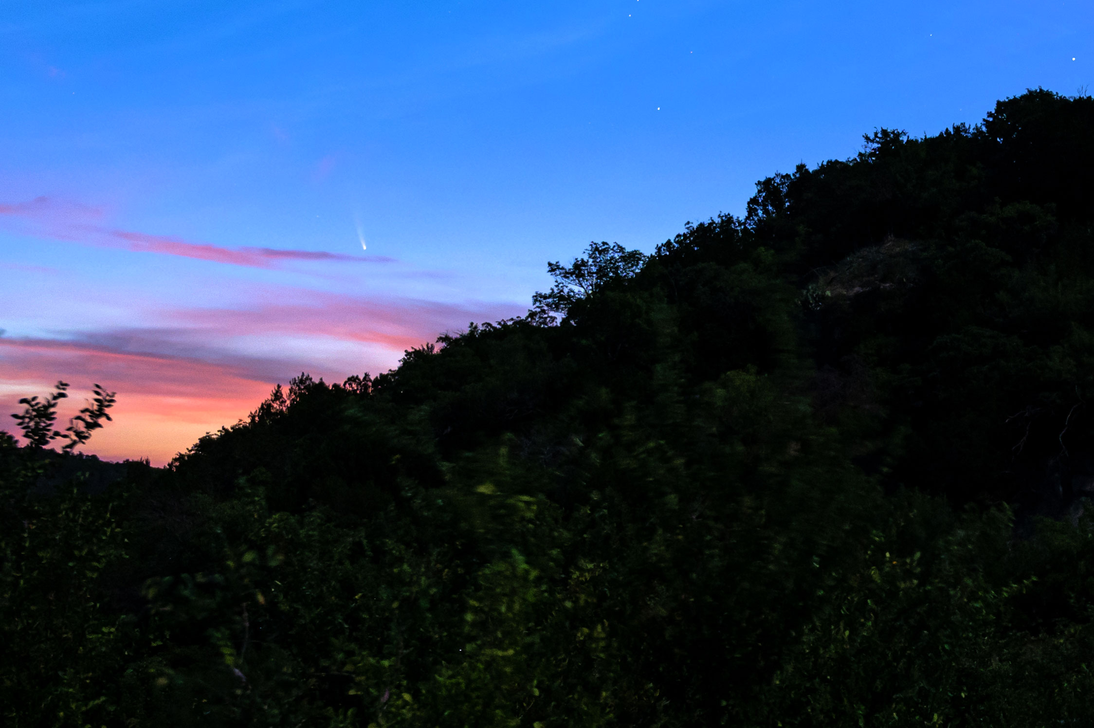 Comet neowise over a mountain at sunrise